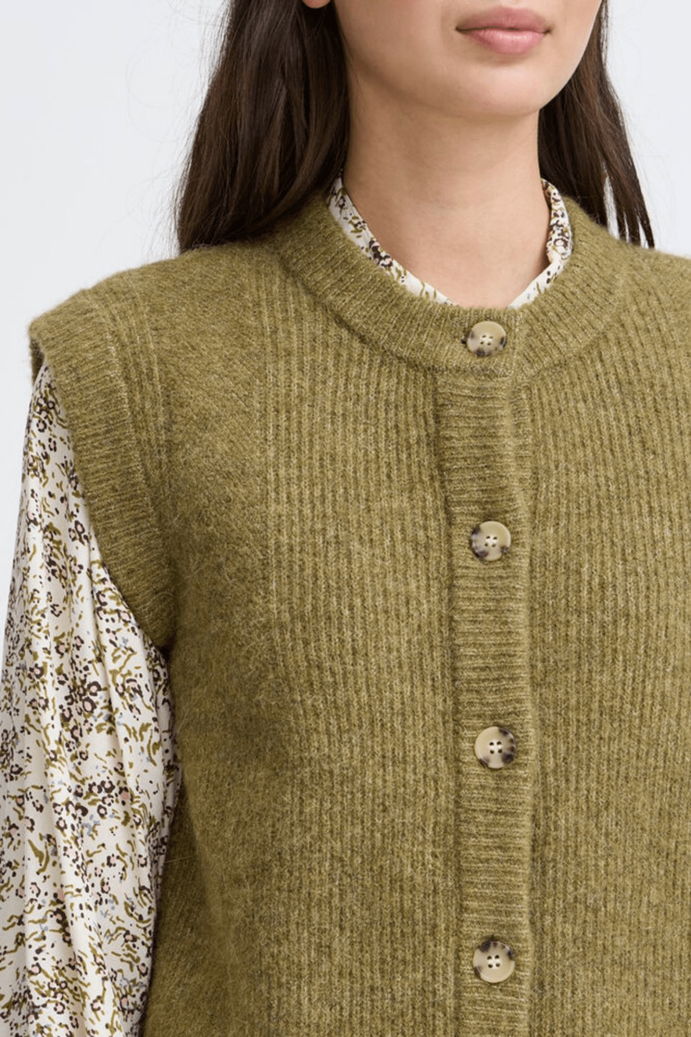 Atelier Rêve Irsilvi Waistcoat, crafted in a cosy moss melange green knit. Available at Dotique Witney