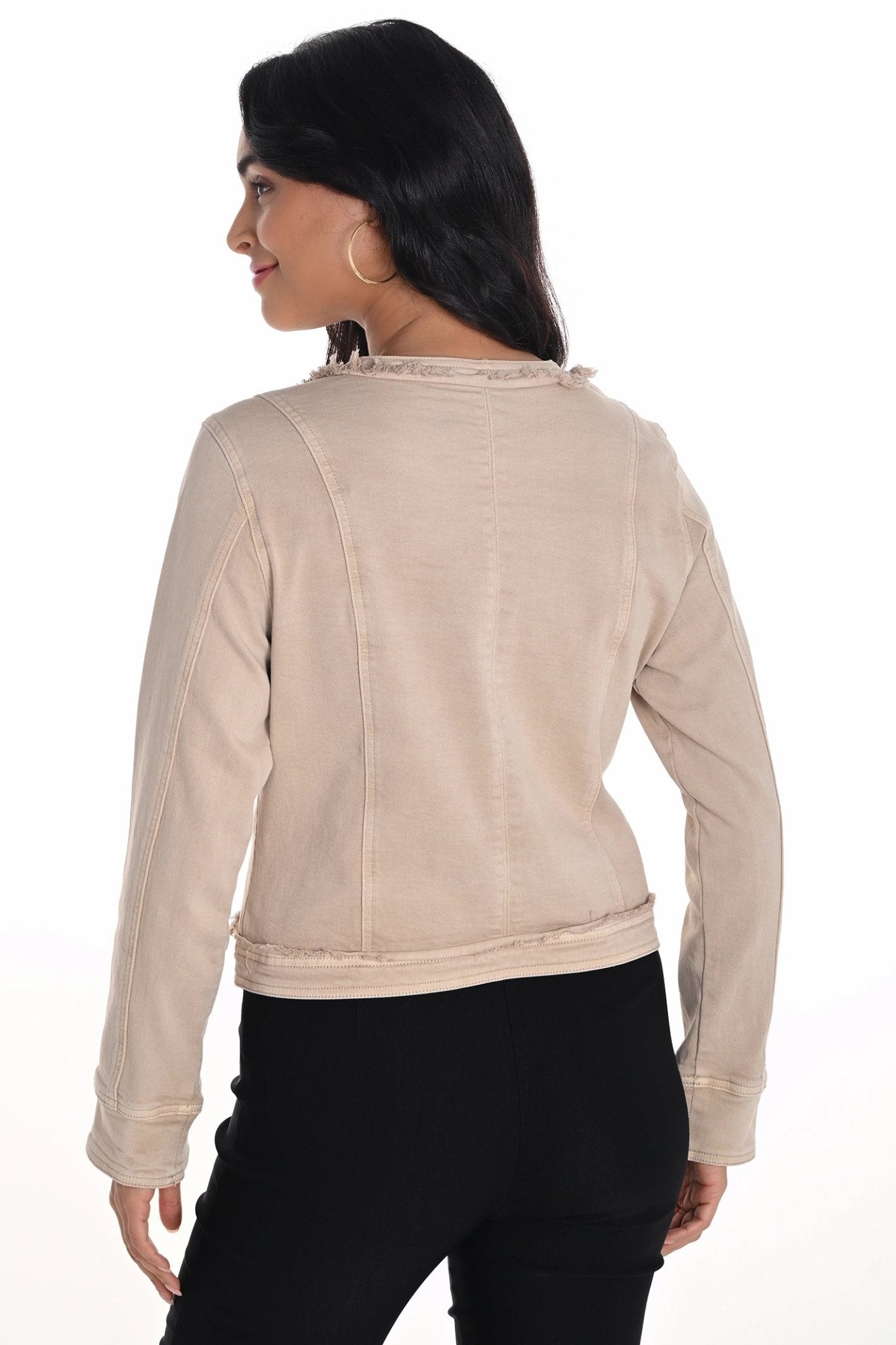 Woman wearing a beige jacket on a white background