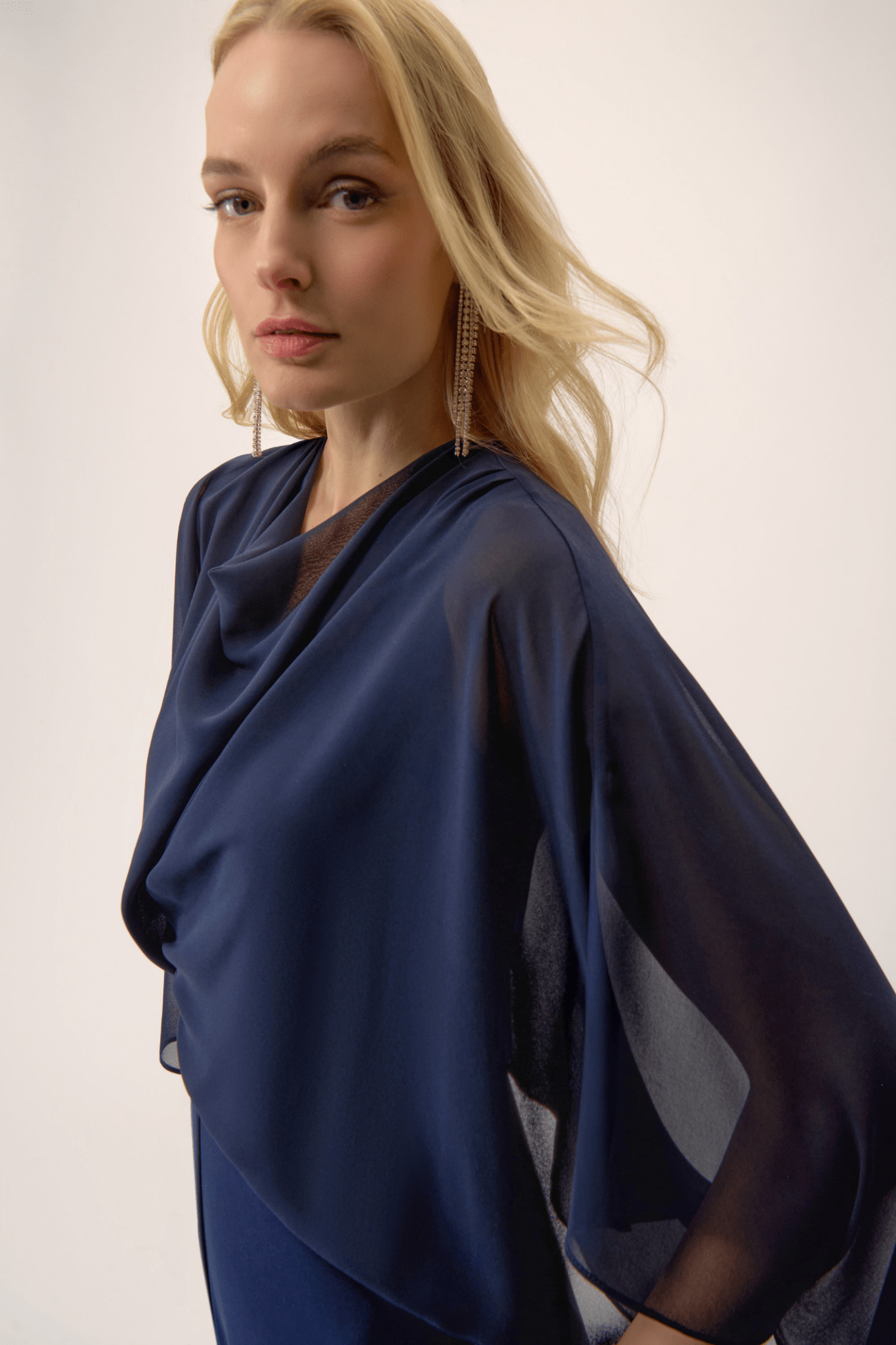 Joseph Ribkoff midnight blue silky knit wide-leg jumpsuit with chiffon poncho overlay and cowl neckline