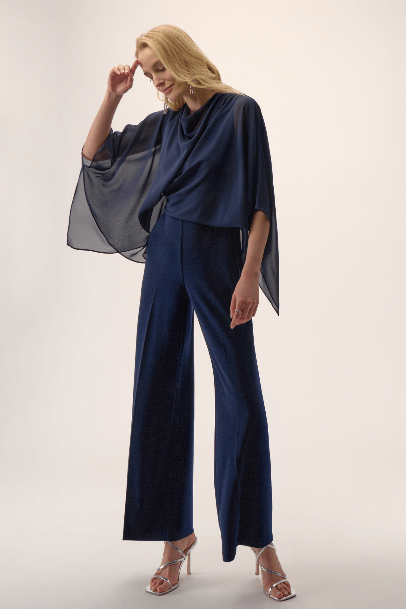 Joseph Ribkoff midnight blue silky knit wide-leg jumpsuit with chiffon poncho overlay and cowl neckline