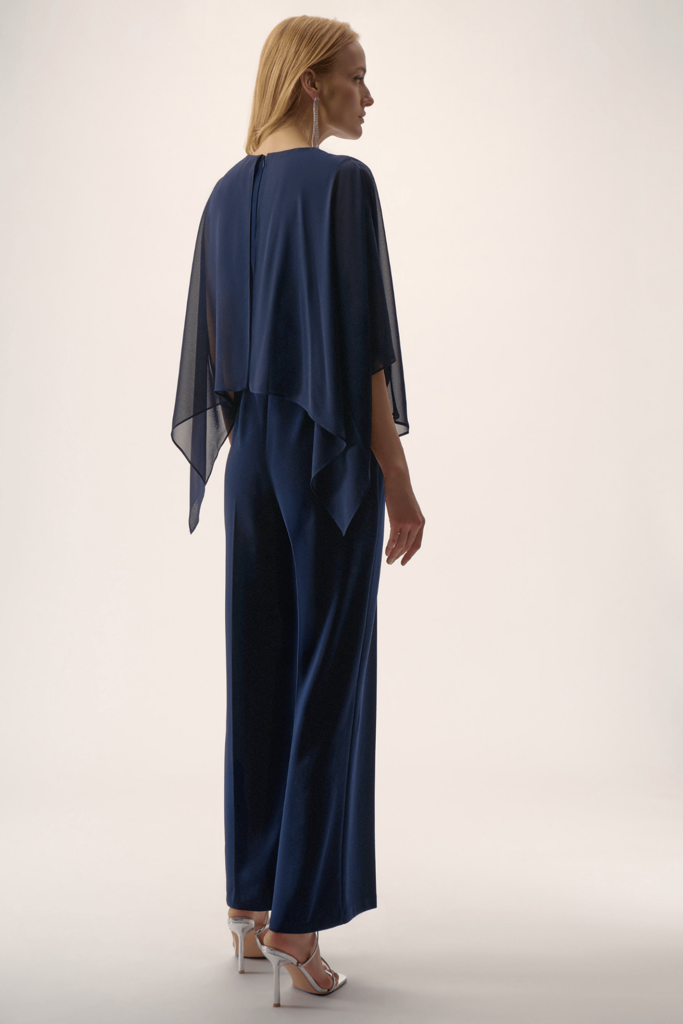 Joseph Ribkoff midnight blue silky knit wide-leg jumpsuit with chiffon poncho overlay and cowl neckline