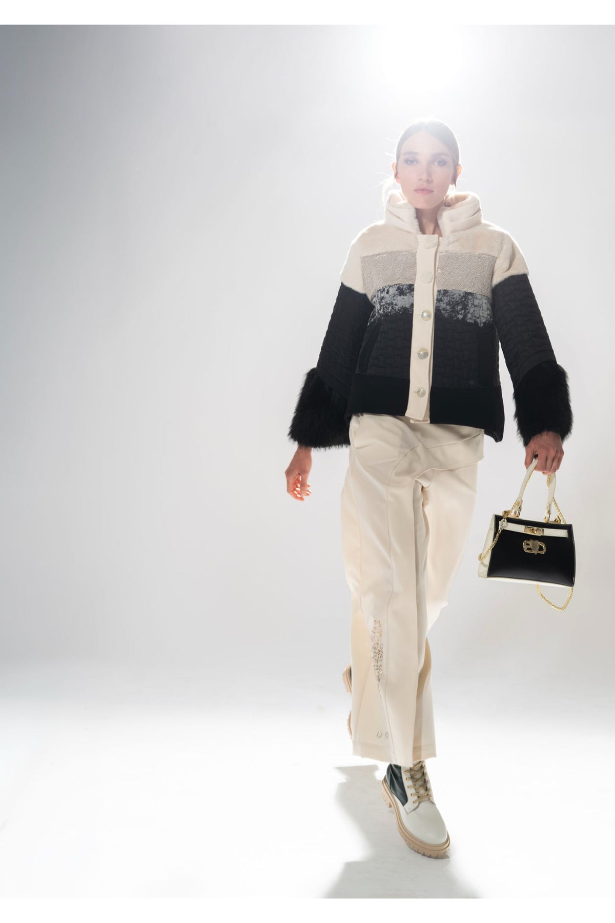 Model wearing Elisa Cavaletti color-block jacket and beige pants, styled with black handbag, shop Elisa Cavaletti at Dotique