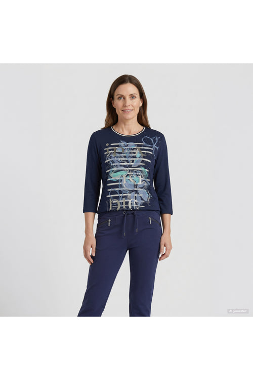 Woman wearing a navy graphic top and matching drawstring pants