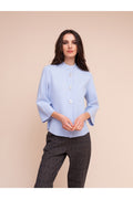 Model wearing the Alison Sheri A48211 Knit Top Ice Blue with unique buttons and 3/4 sleeves, shop Alison Sheri at Dotique.