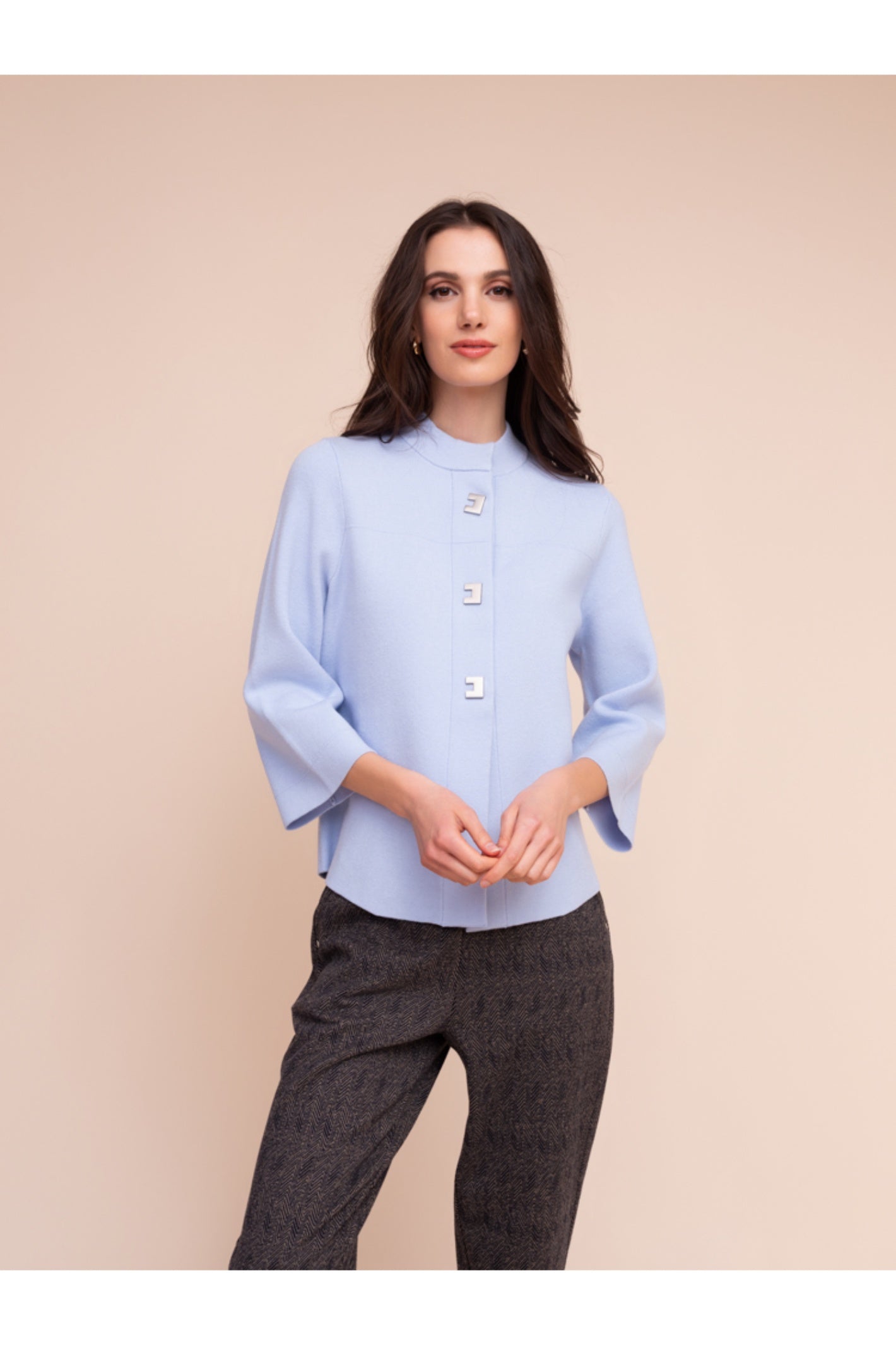 Model wearing the Alison Sheri A48211 Knit Top Ice Blue with unique buttons and 3/4 sleeves, shop Alison Sheri at Dotique.