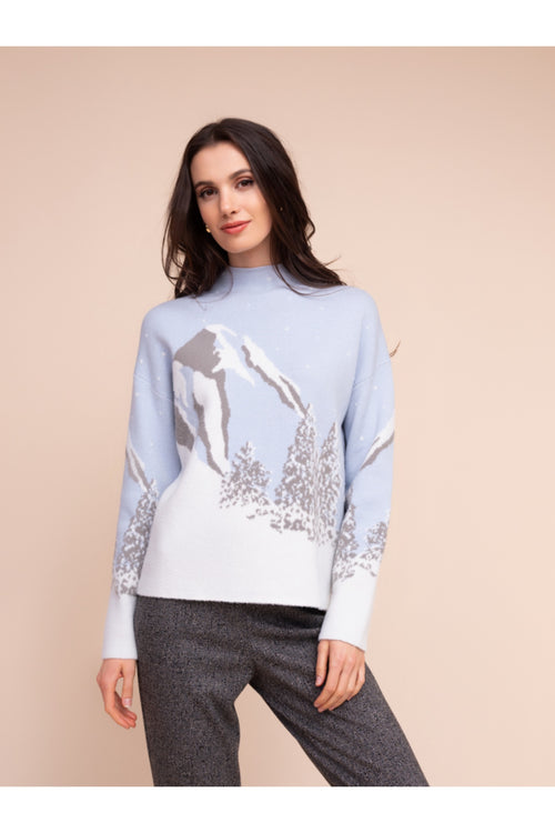 Model wearing the Alison Sheri A48302 Knit Top by Alison Sheri featuring a winter mountain landscape design, shop Alison Sheri at Dotique.