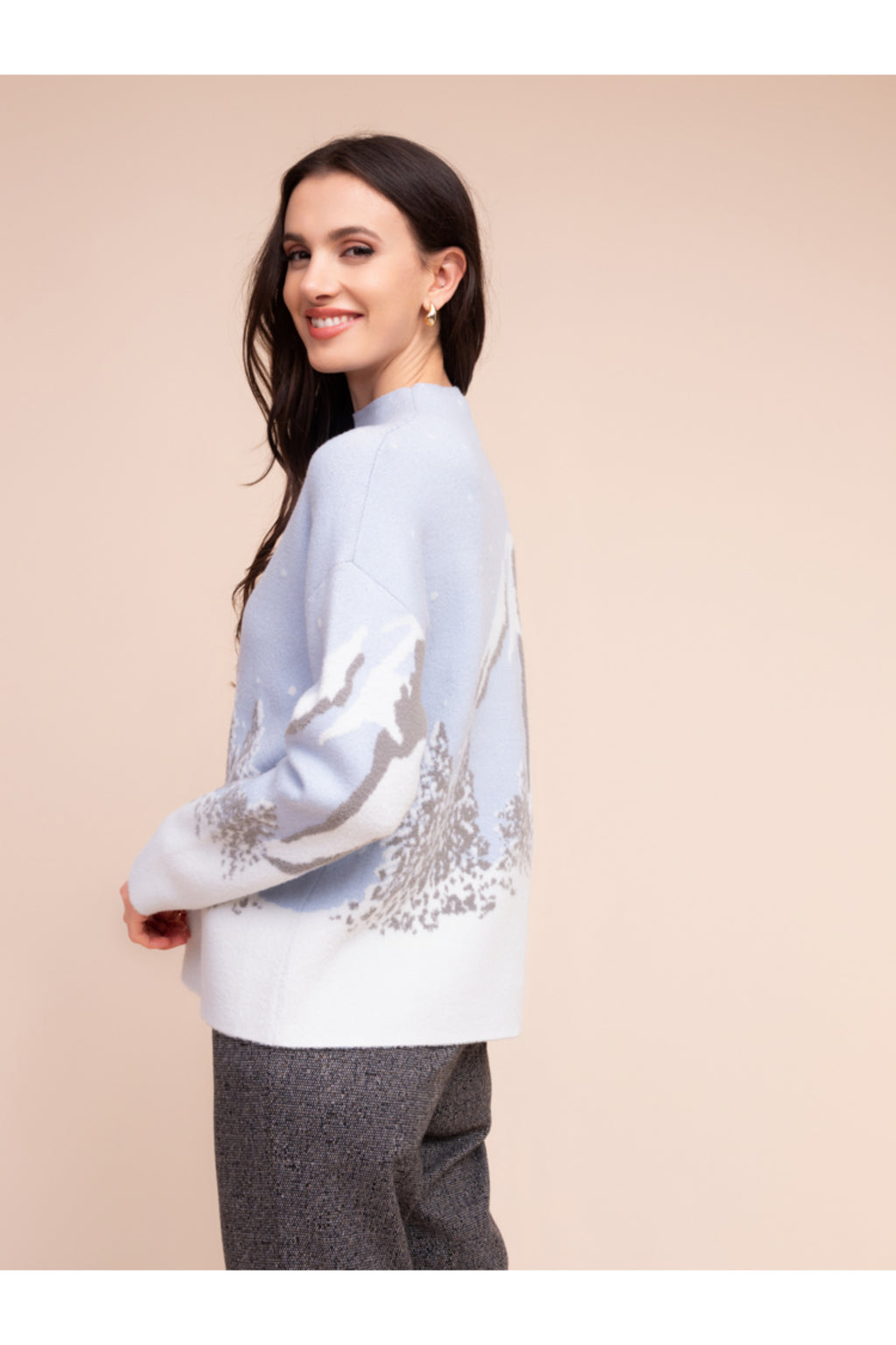 Model smiling wearing the Alison Sheri A48302 Knit Top in soft pastel tones with a nature-inspired pattern by Alison Sheri, shop Alison Sheri at Dotique.