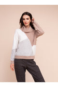 Model wearing the Alison Sheri A48310 Knit Top by Alison Sheri in a colorblock pattern with a cozy turtleneck, shop Alison Sheri at Dotique.
