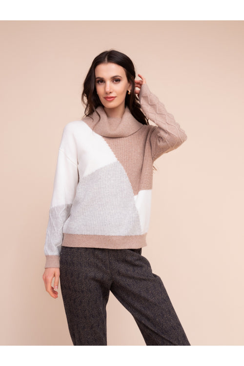 Model wearing the Alison Sheri A48310 Knit Top by Alison Sheri in a colorblock pattern with a cozy turtleneck, shop Alison Sheri at Dotique.