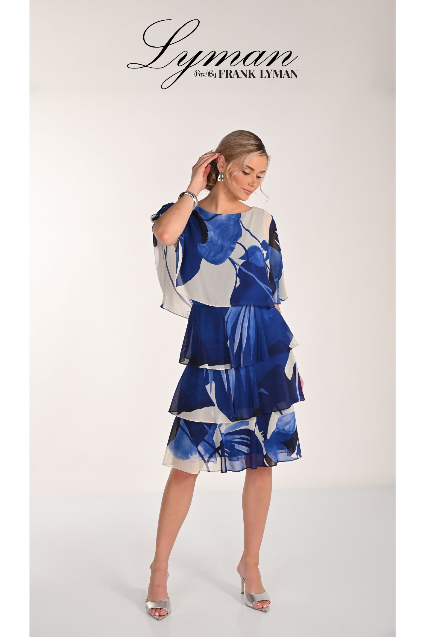 Model wearing Frank Lyman 268221 Blue Floral Tiered Chiffon Dress by Frank Lyman, shop Frank Lyman at Dotique.