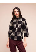 Model wearing the Alison Sheri A48055 Geometric Knit Top in black and beige geometric pattern with 3/4 sleeves, shop Alison Sheri at Dotique.