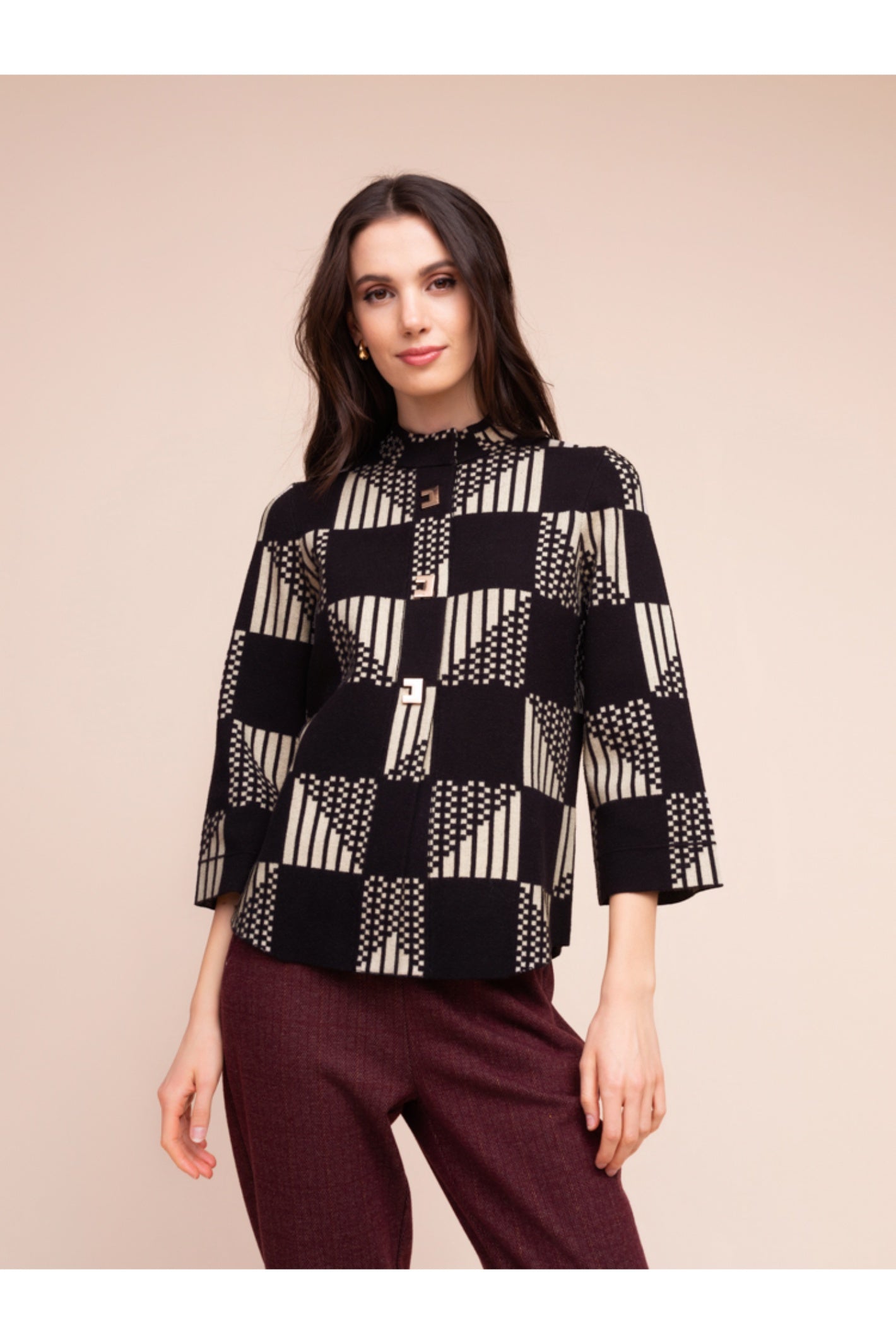 Model wearing the Alison Sheri A48055 Geometric Knit Top in black and beige geometric pattern with 3/4 sleeves, shop Alison Sheri at Dotique.