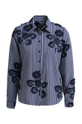 A navy and white vertically striped button-down shirt with dark navy floral applique patches on the front, displayed on a clean white background.