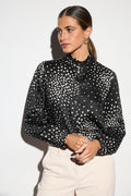 Shop the Bariloche 4007502 Benaoca Women's Shirt in Black at Dotique. A sophisticated spot print blouse with a feminine frill neckline and relaxed fit, perfect for work and occasion dressing.