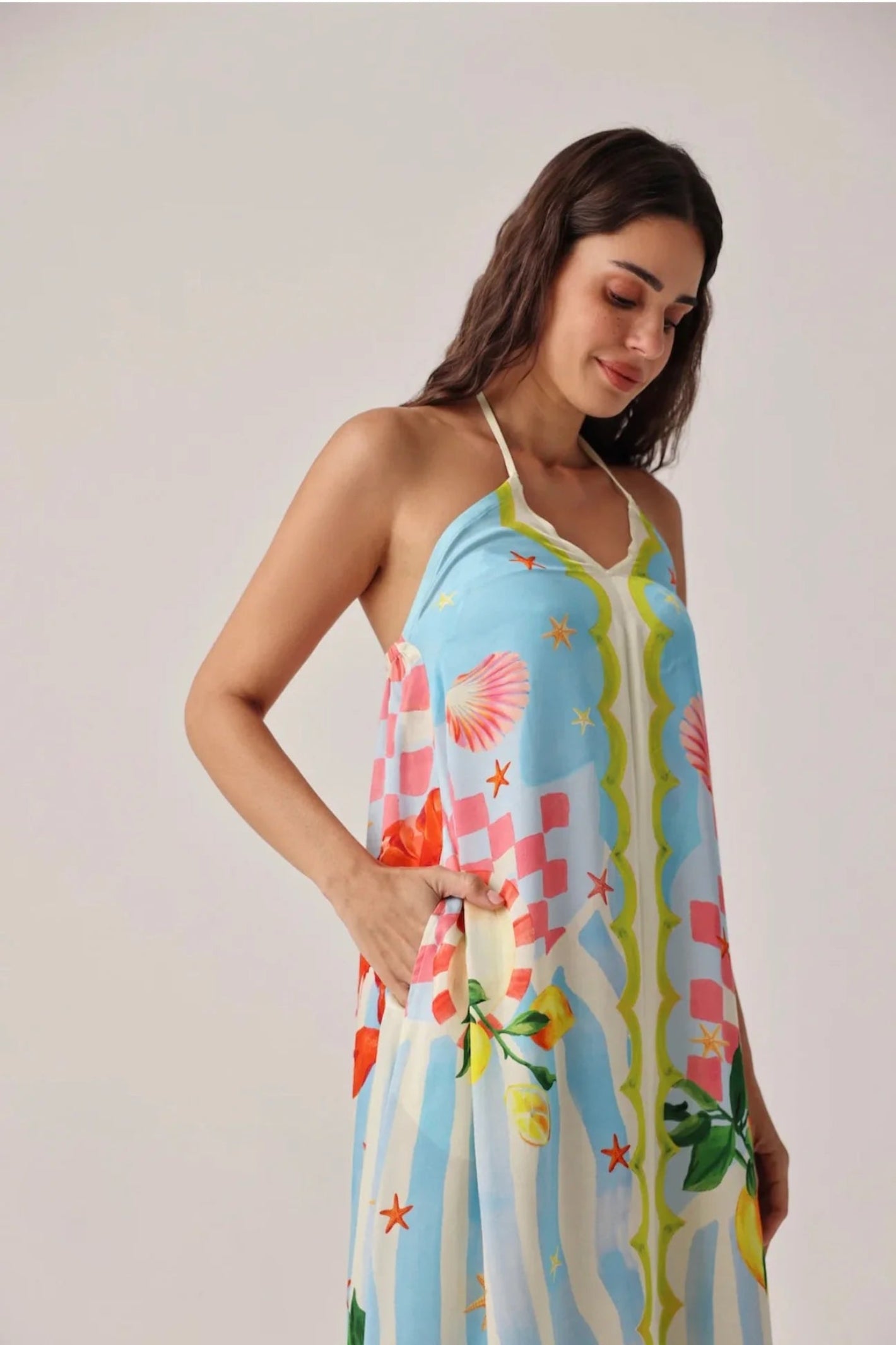 Woman wearing Noib Riva Coverup – Summer Zest with colorful seashell and floral pattern by Noib. Shop Noib at Dotique.