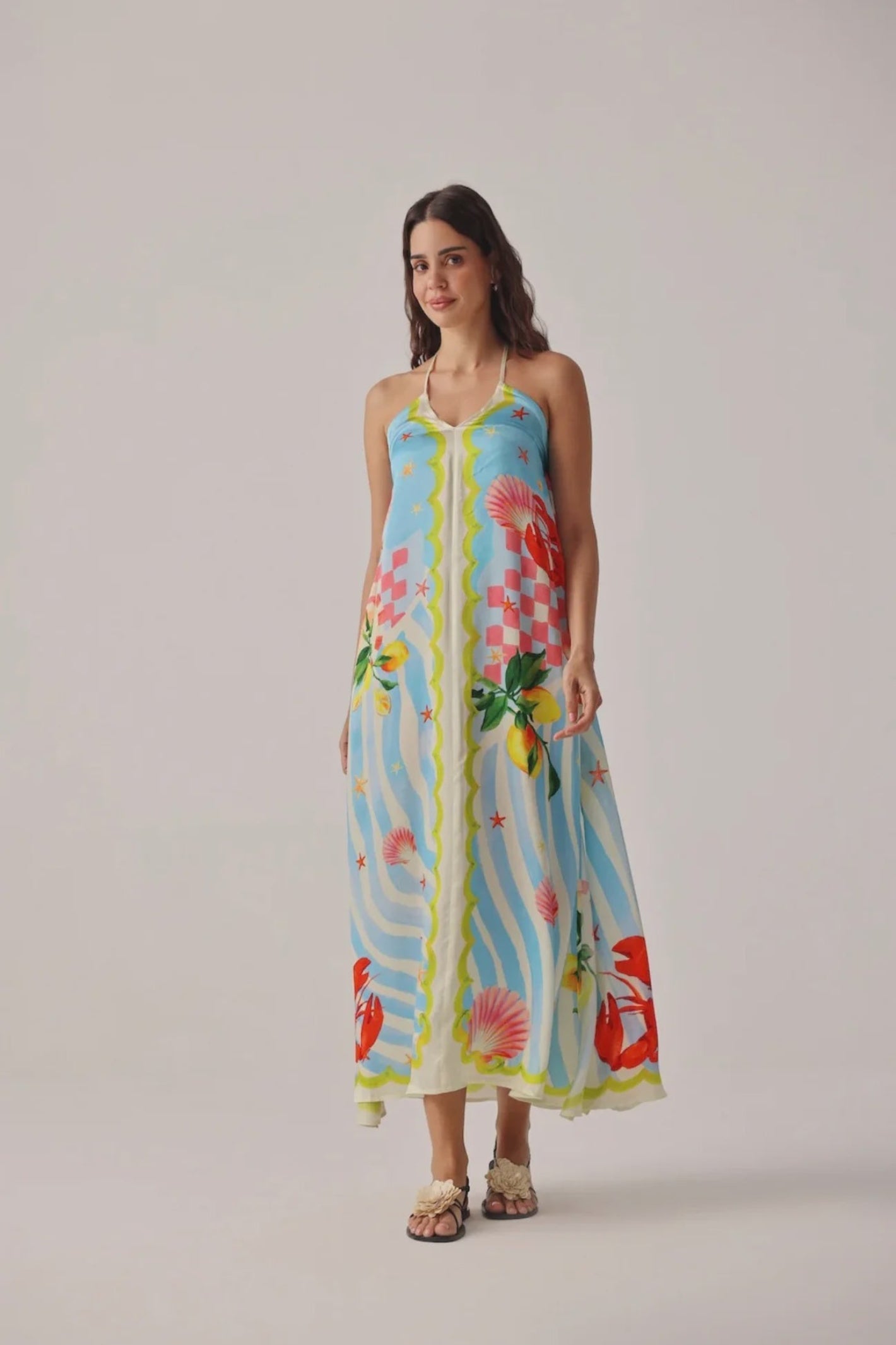 Model wearing Noib Riva Coverup – Summer Zest with colorful seashell and floral print by Noib. Shop Noib at Dotique.
