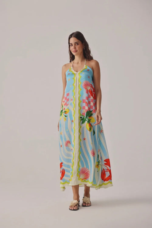 Model wearing Noib Riva Coverup – Summer Zest with colorful seashell and floral print by Noib. Shop Noib at Dotique.