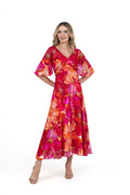 Model wearing Allison 6160 Red Orange Dress with vibrant floral pattern and flutter sleeves by Allison, shop Allison at Dotique.