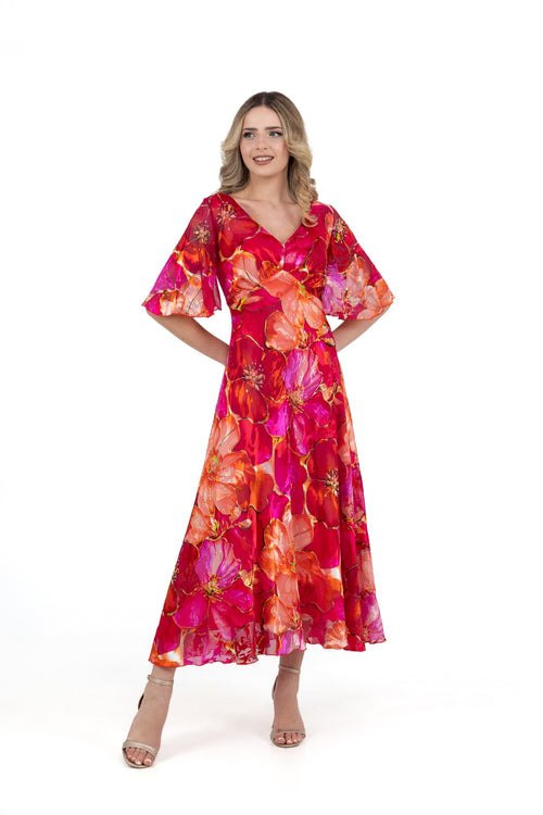 Model wearing Allison 6160 Red Orange Dress with vibrant floral pattern and flutter sleeves by Allison, shop Allison at Dotique.
