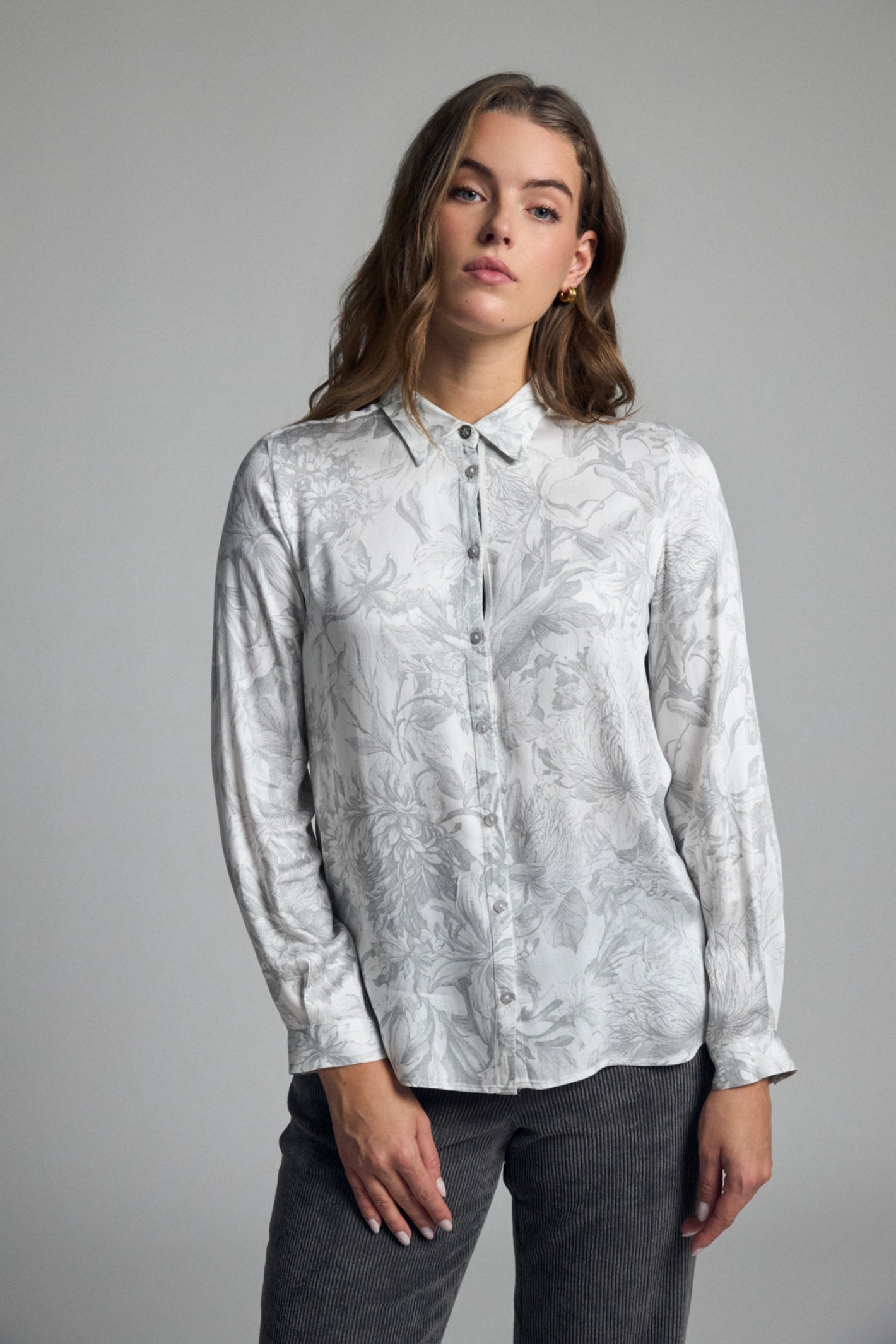 Shop the Bariloche 4008816 Egea-C Women's Shirt in Light Grey at Dotique. A beautifully draped floral print blouse with a classic collar and timeless styling for work and everyday wear.