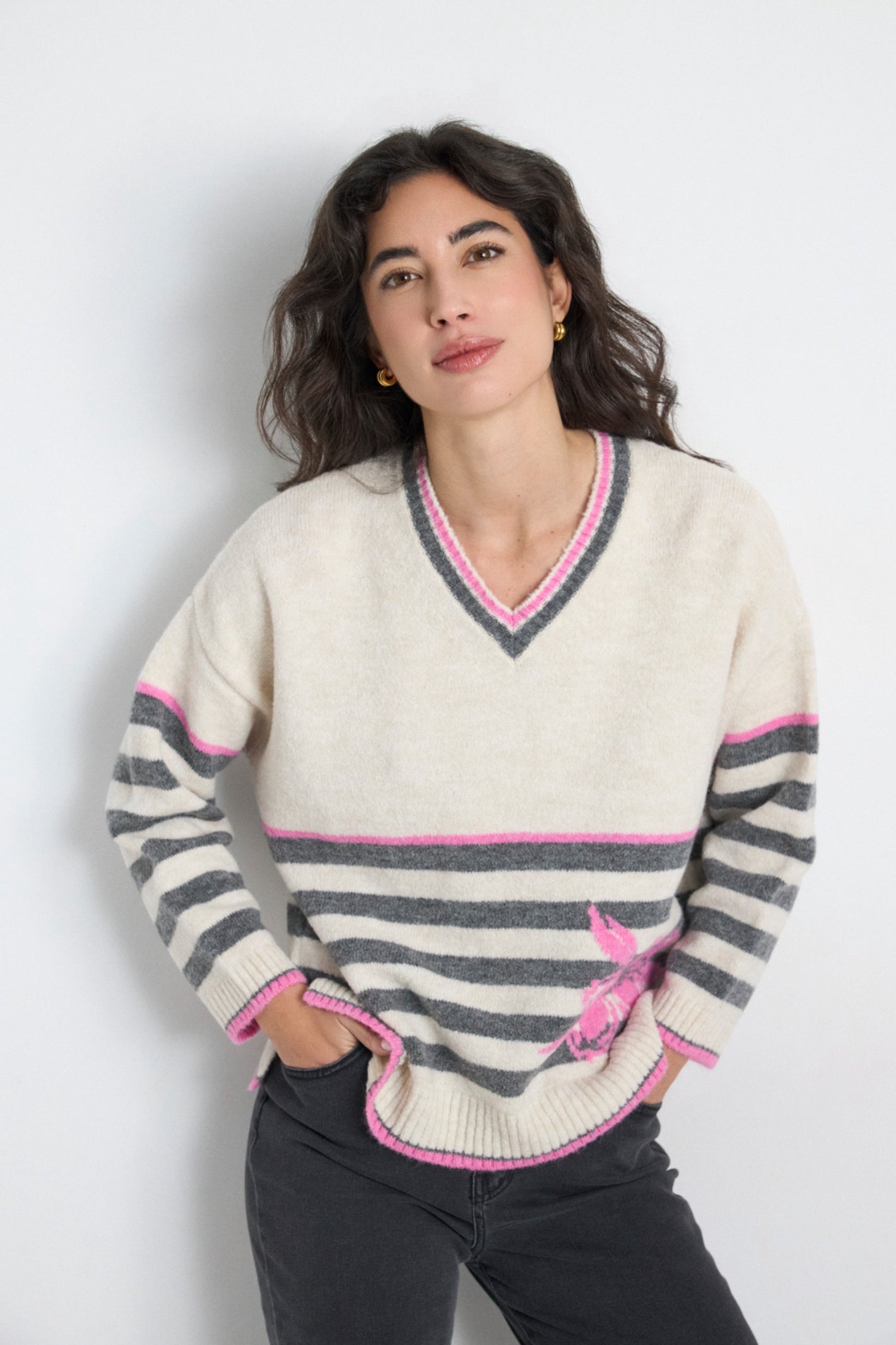 Shop the Tinta 4025768 Eudora Women's Knitwear in Natural at Dotique. A soft striped V-neck jumper with pink contrast detailing and an embroidered lobster motif for a fun everyday look.