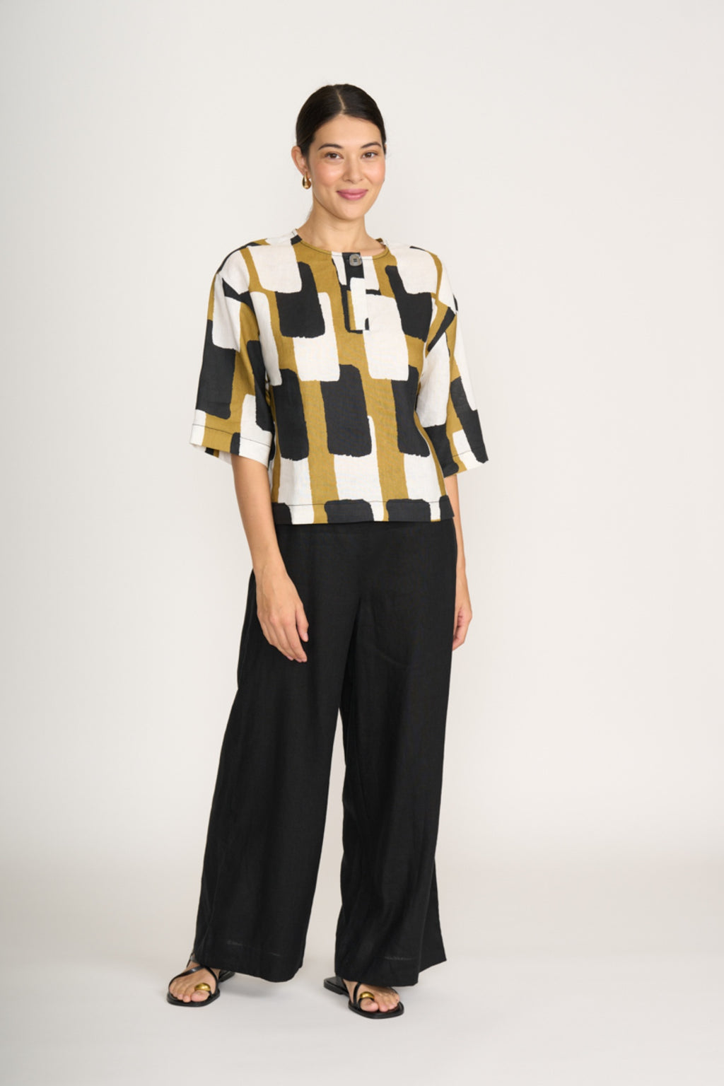Woman wearing Foil Fo8232 Looking Sharp Top Art Box by Foil paired with black pants Shop Foil at Dotique