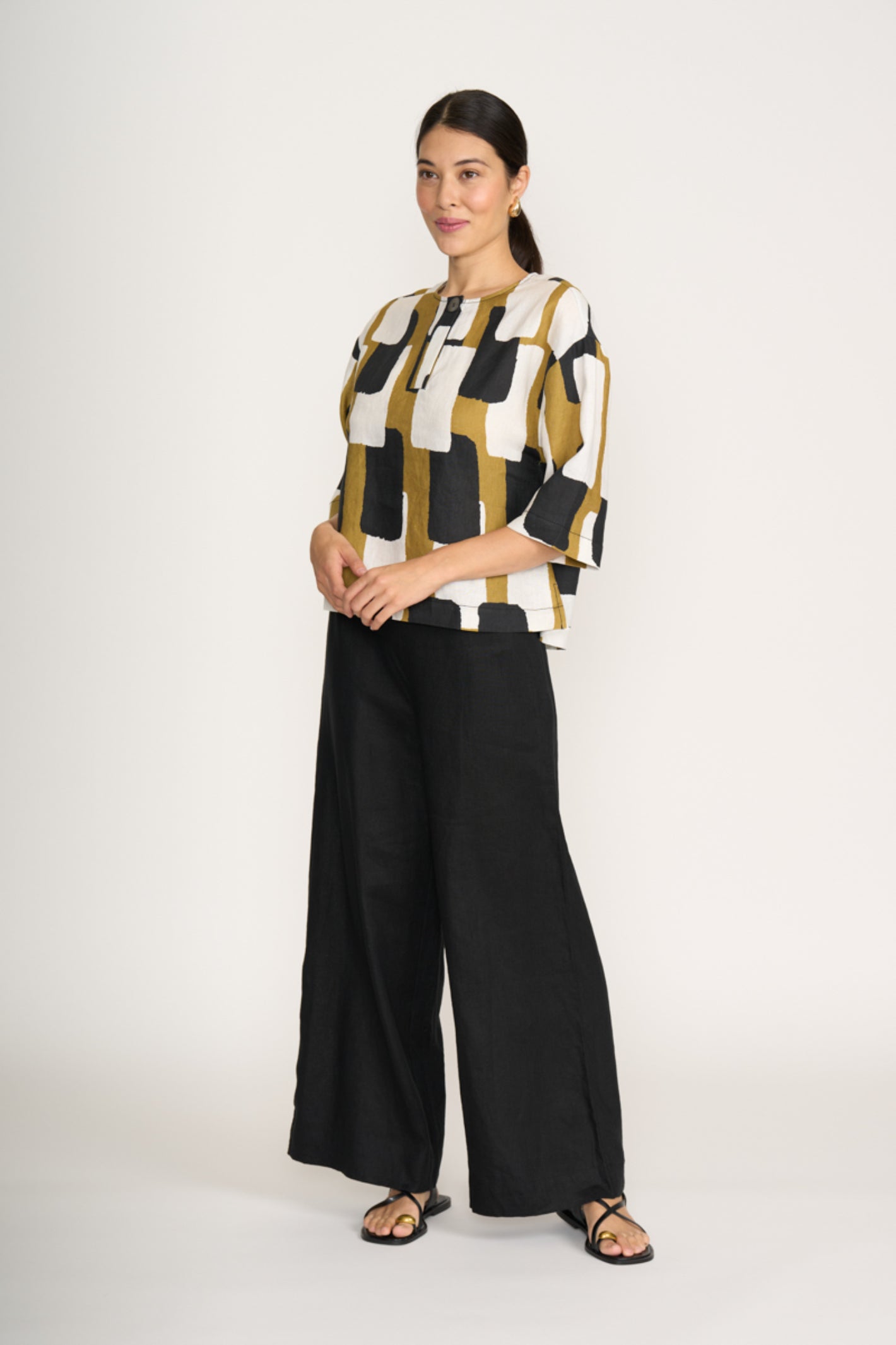 Woman wearing Foil Fo8232 Looking Sharp Top Art Box by Foil paired with black pants Shop Foil at Dotique
