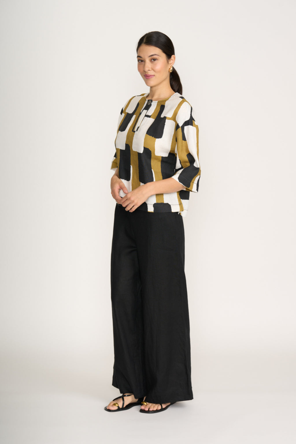 Woman wearing Foil Fo8232 Looking Sharp Top Art Box by Foil styled with black pants shop Foil at Dotique