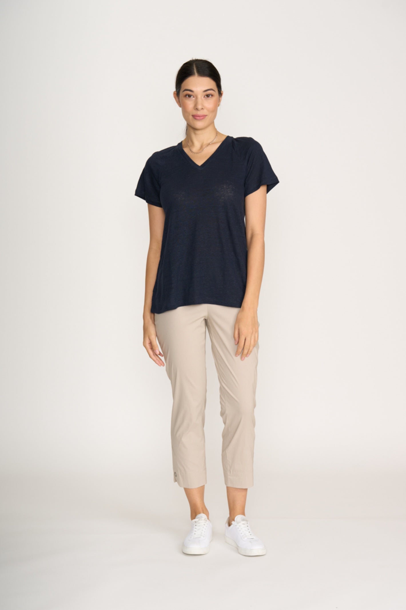 Woman wearing navy top and Foil Fo8269 Finish Line Pant Sand by Foil, shop the Foil range at Dotique