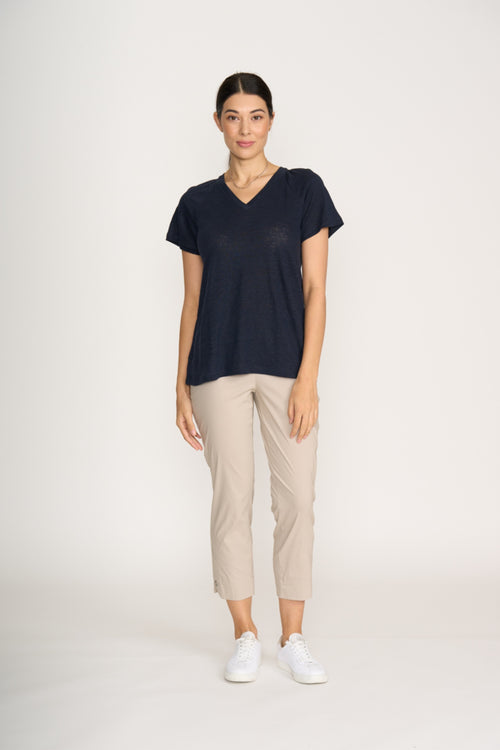 Woman wearing navy top and Foil Fo8269 Finish Line Pant Sand by Foil, shop the Foil range at Dotique