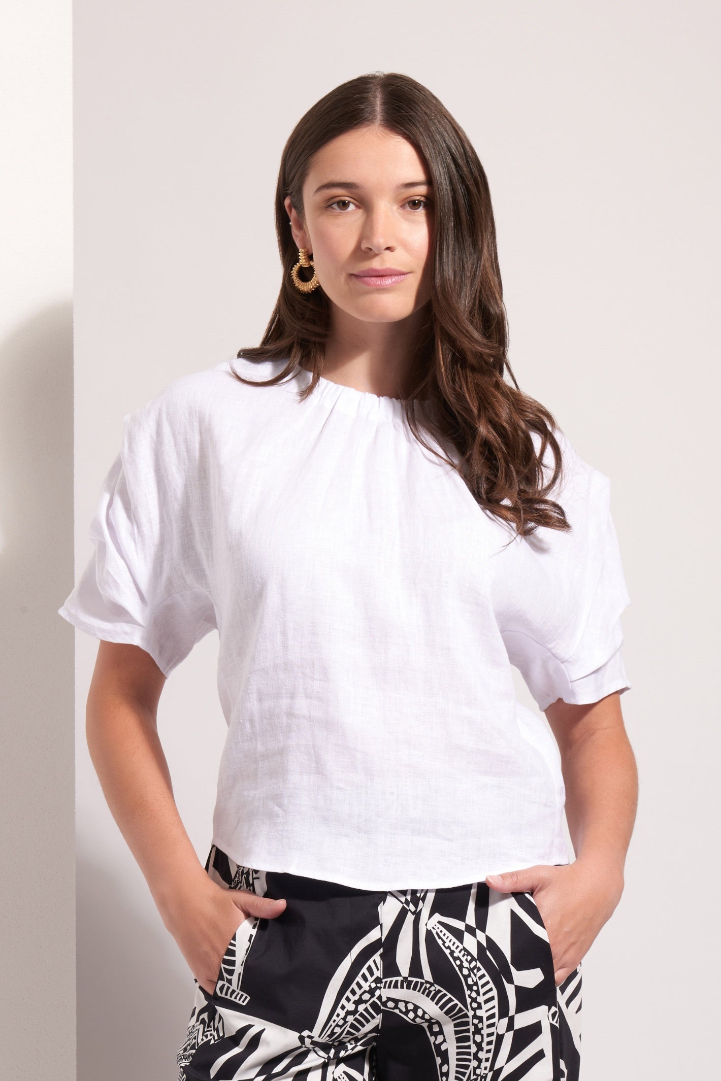 Woman wearing Foil Fo8257 Pleat Greet Top White by Foil hands in pockets shop Foil at Dotique