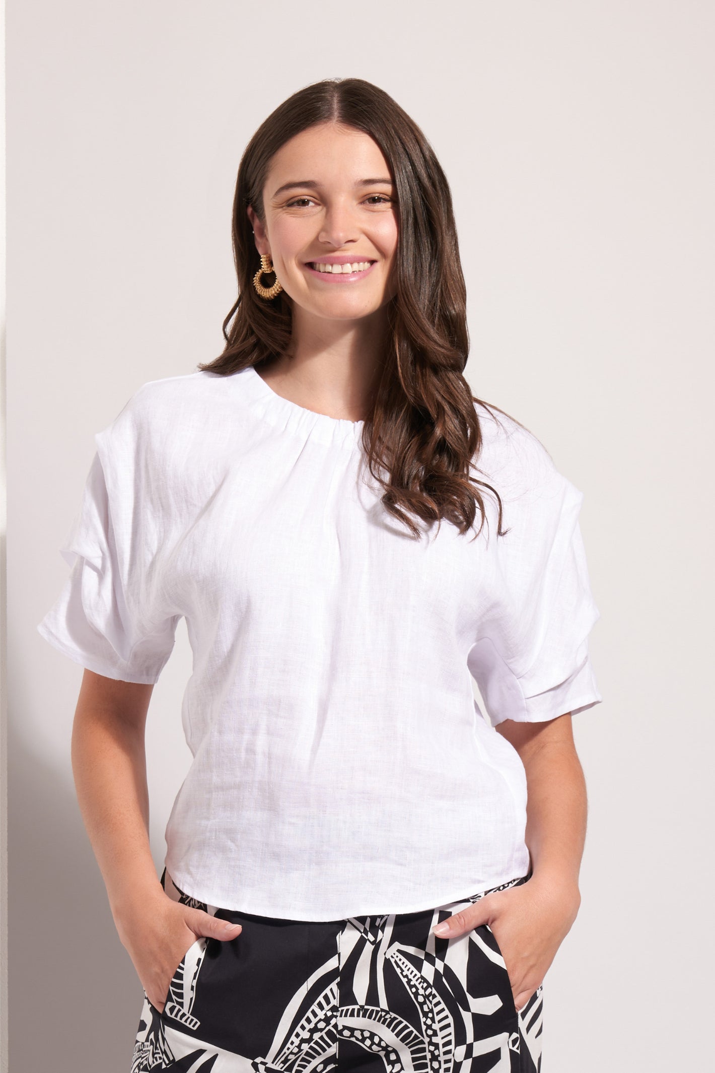 Smiling woman wearing Foil Fo8257 Pleat Greet Top White by Foil Shop the vendor Foil at Dotique online store