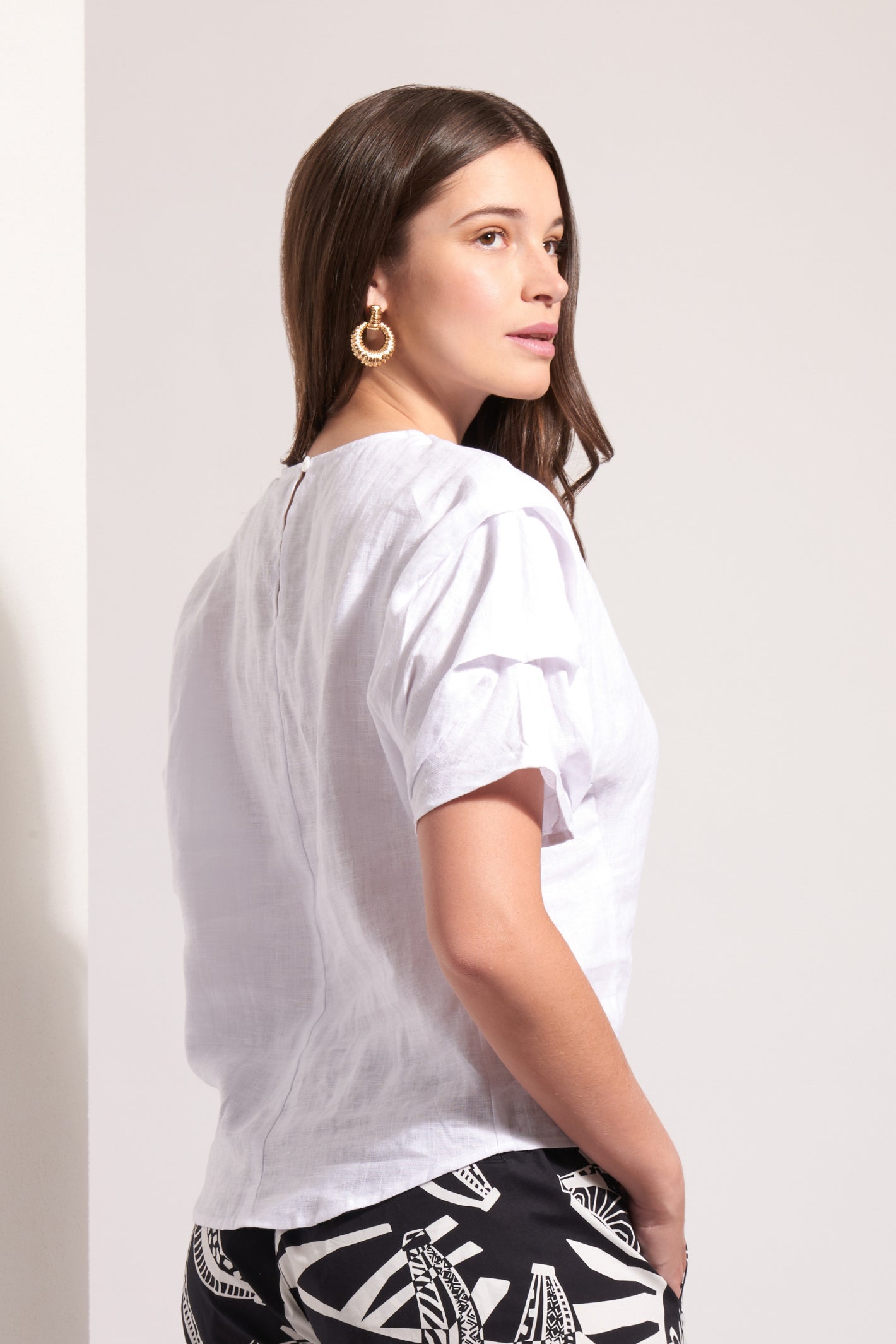 Foil Fo8257 Pleat Greet Top White by Foil shown on model, shop the brand exclusively at Dotique online store.