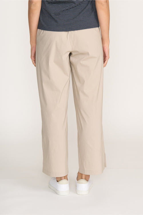Rear view of model wearing Foil Fo8259 Broad Horizon Trousers Sand by Foil Shop at Dotique