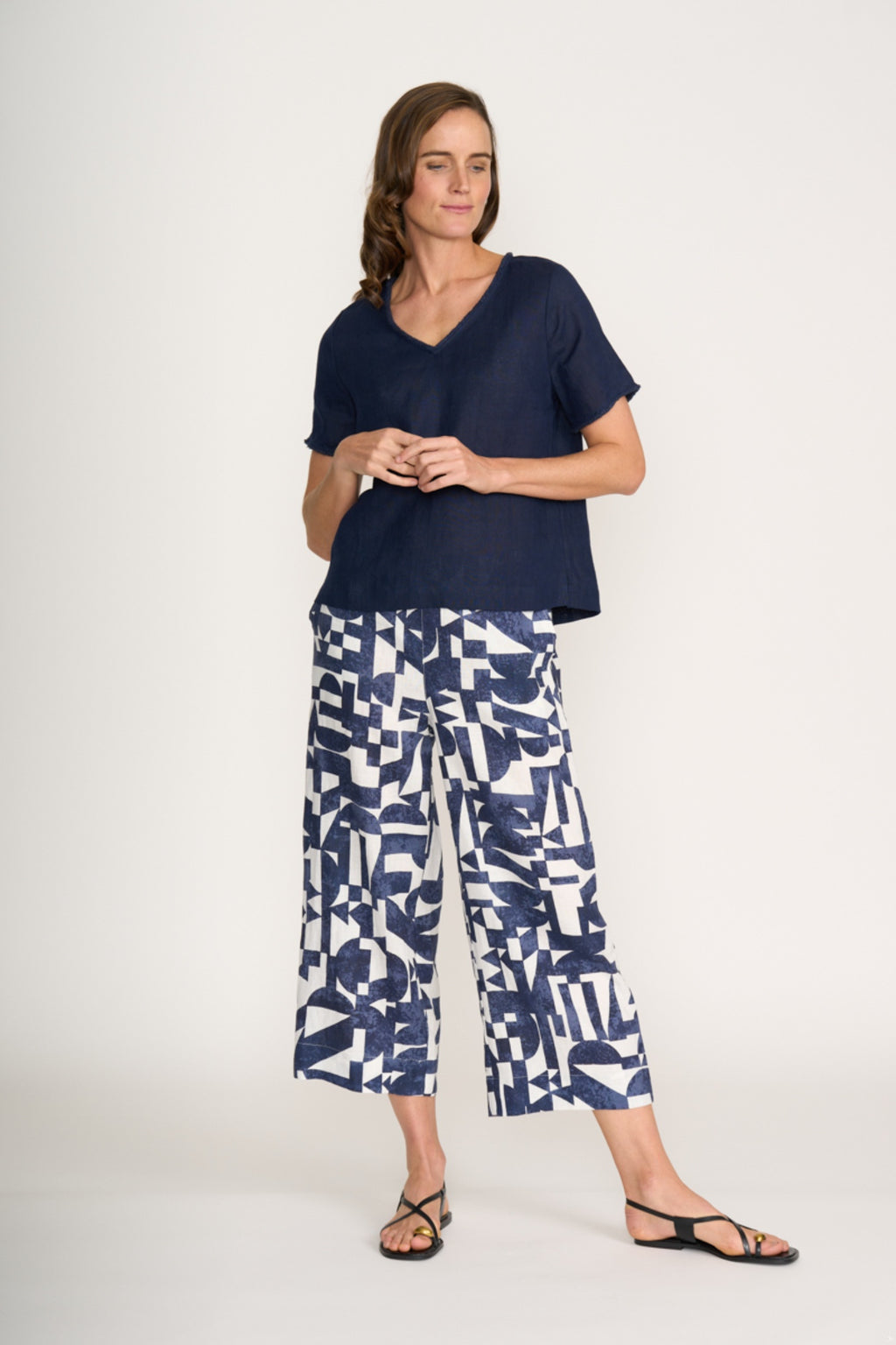Woman wearing Foil Fo8315 V Benefits Top Eclipse with printed pants, shop Foil at Dotique for relaxed, flattering style