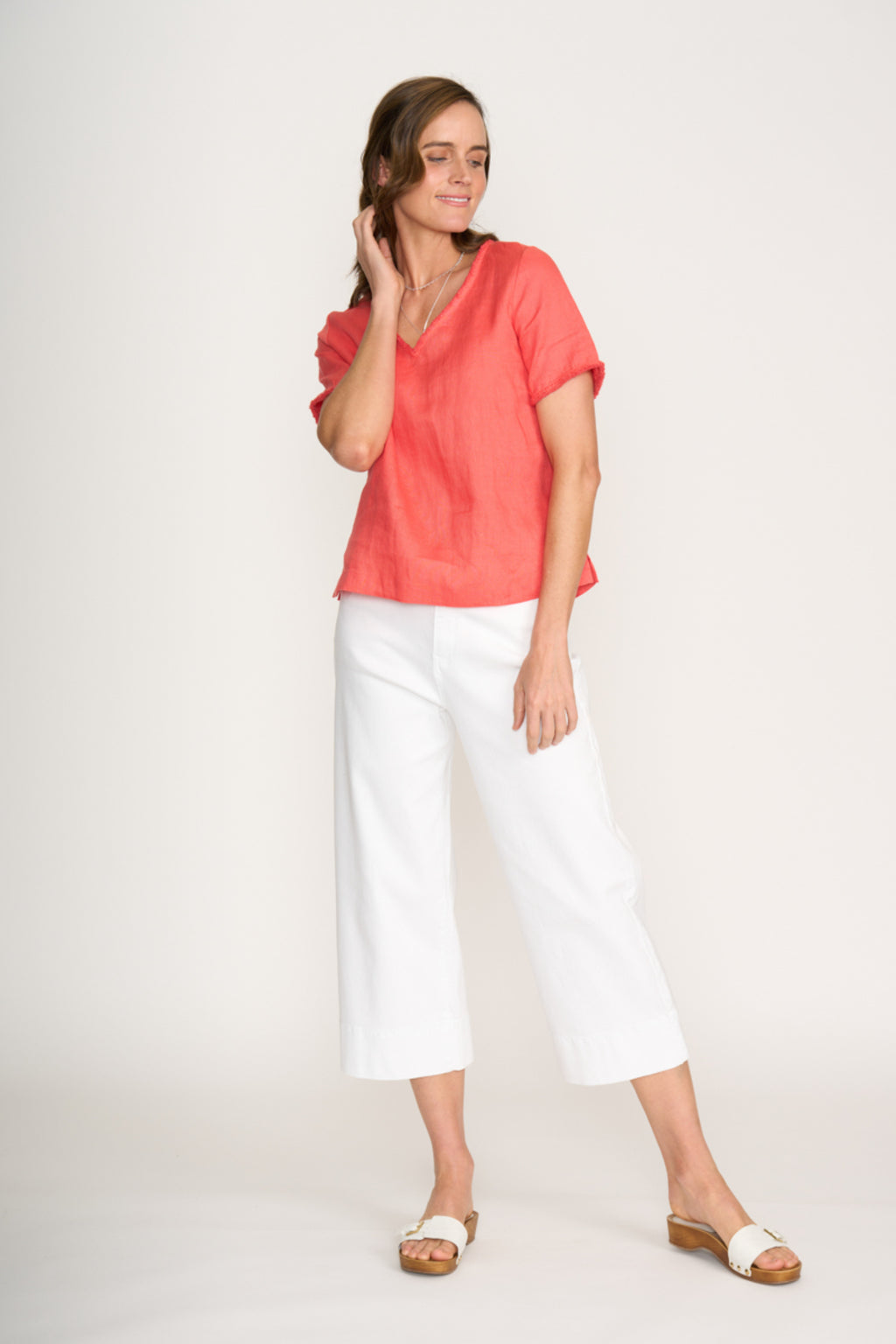 Woman wearing Foil Fo8315 V Benefits Top Melon relaxed fit with white pants shop Foil at Dotique online store
