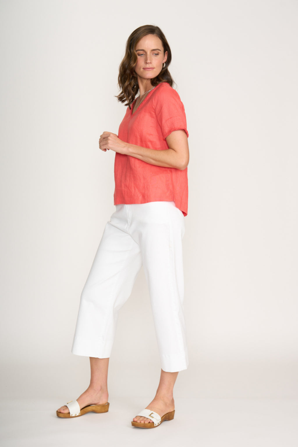 Woman wearing Foil Fo8315 V Benefits Top Melon by Foil styled with white pants Shop Foil at Dotique