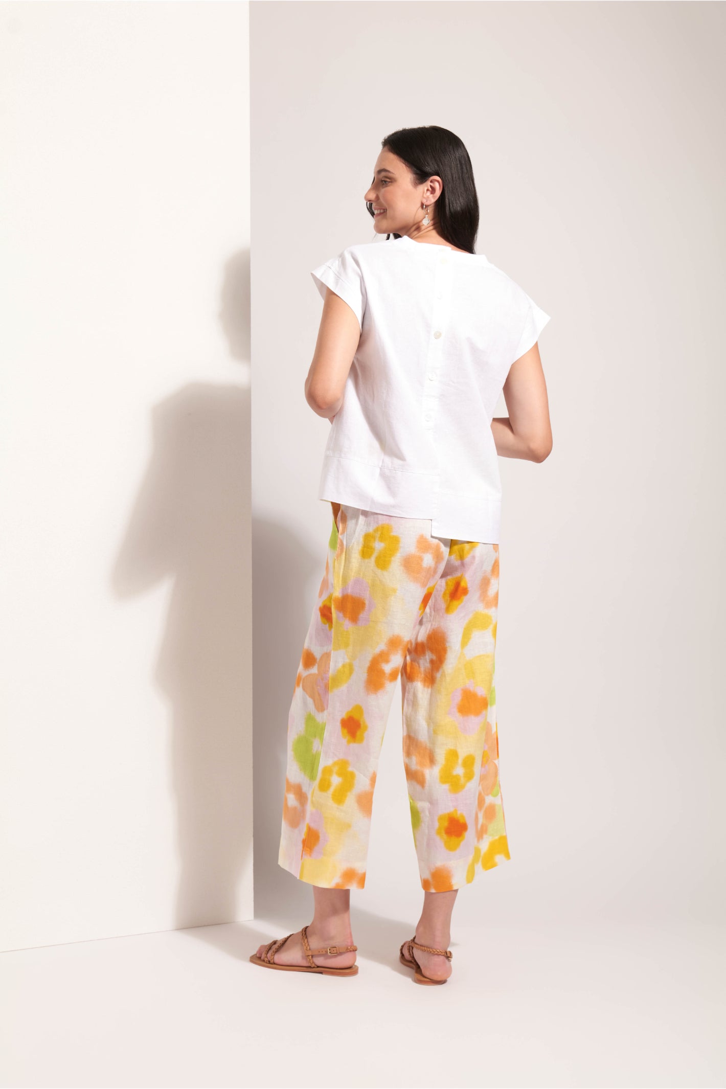 Woman wearing Foil Fo8341 Cut Of Your Rib Top White, styled with floral pants, shop Foil at Dotique for chic fashion.