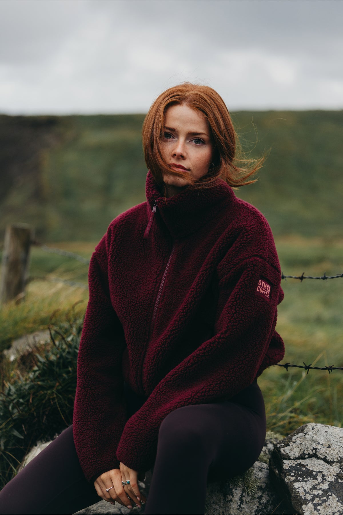 Gym+Coffee Industry Fleece High Collar Jacket Cherry Crush worn by a woman outdoors Shop Gym+Coffee at Dotique