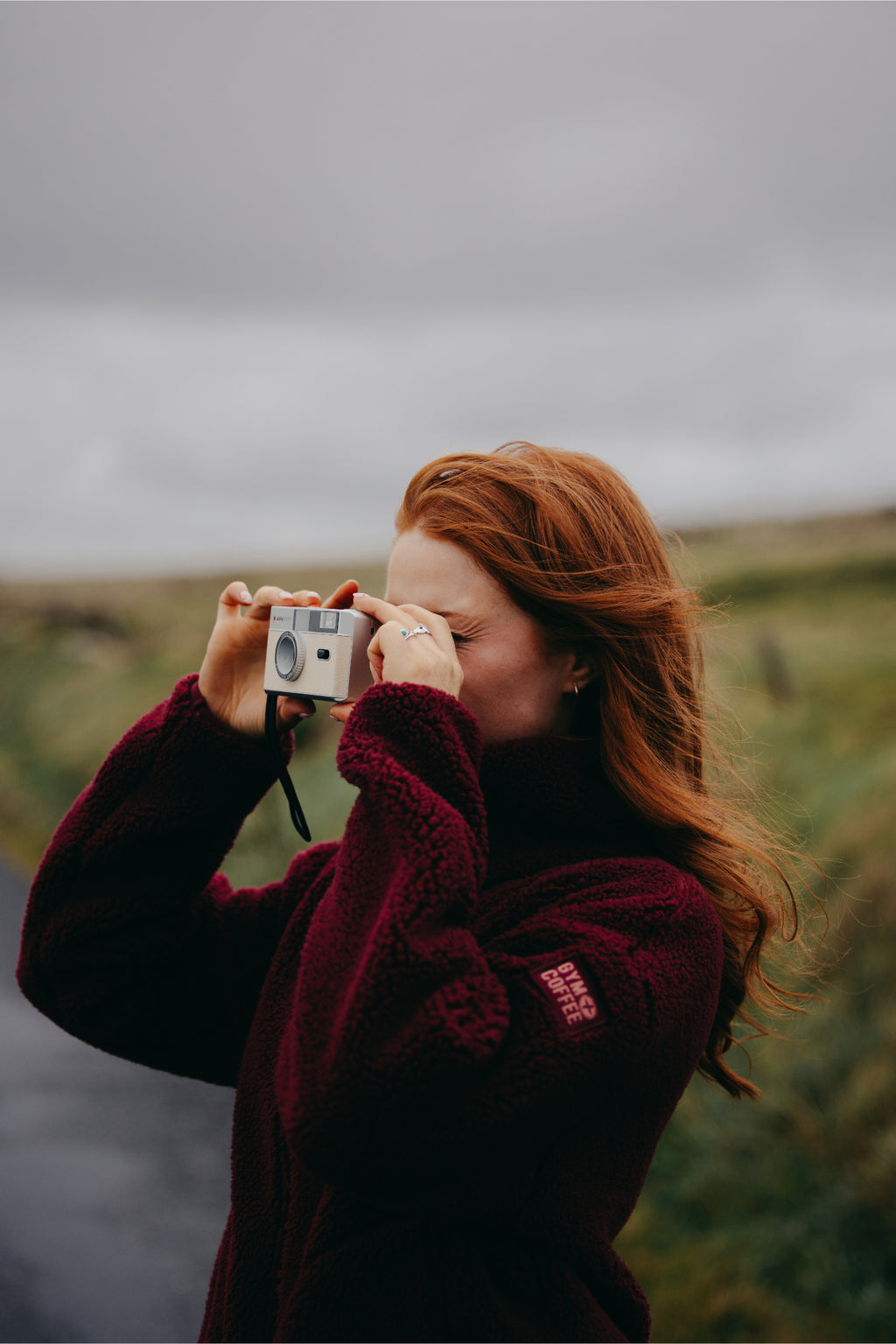 Gym+Coffee Industry Fleece High Collar Jacket Cherry Crush worn by woman with camera Shop Gym+Coffee at Dotique