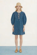 Model wearing Tiny Big Sister Puff Sleeves Denim Dress with lace-up detail by Tiny Big Sister, shop Tiny Big Sister at Dotique gallery 1