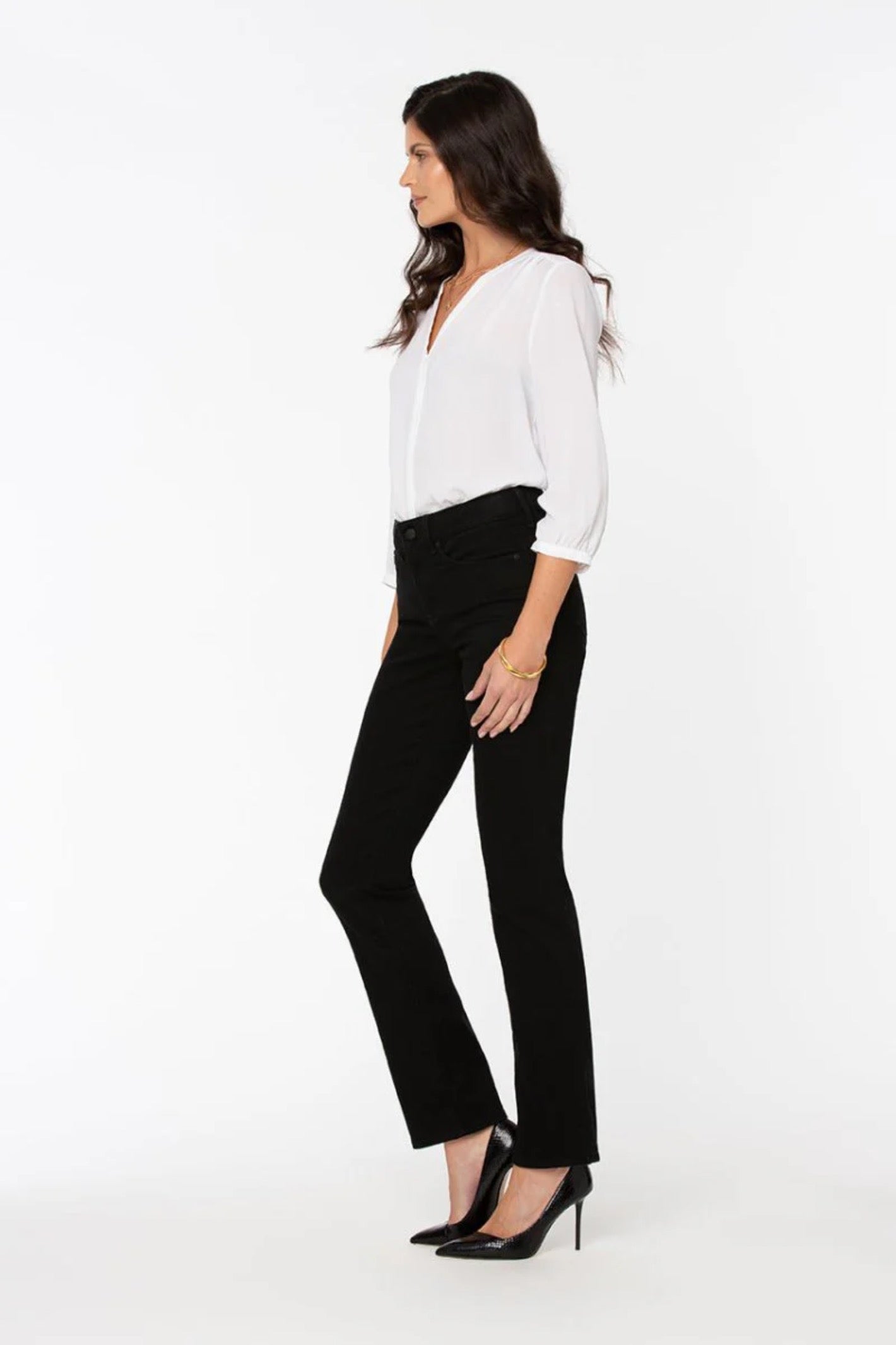 Woman wearing NYDJ Marilyn Straight Black Jeans 30” styled with black heels and white blouse, shop NYDJ at Dotique