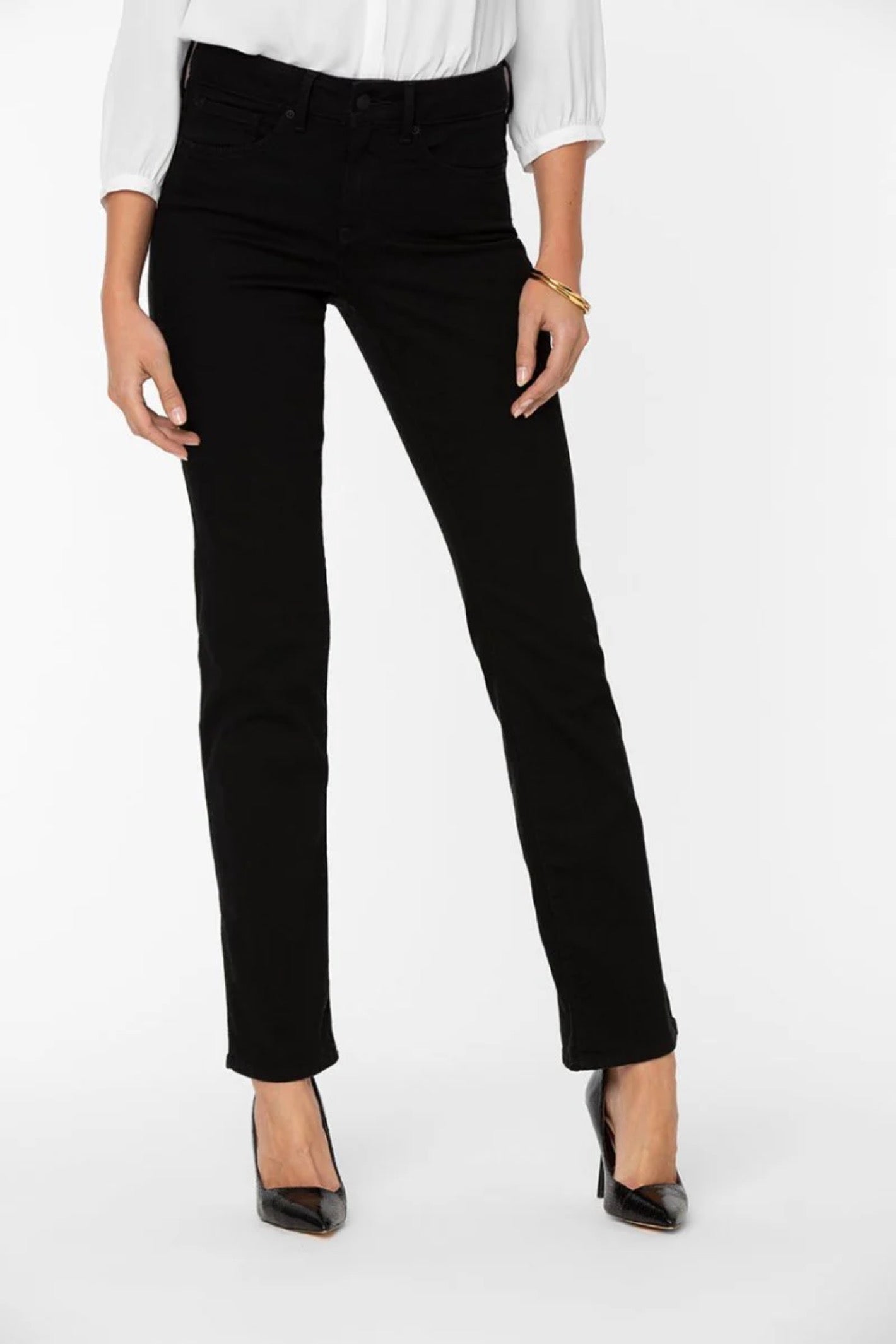 Woman wearing NYDJ Marilyn Straight Black Jeans 30” paired with heels and white blouse, shop NYDJ at Dotique.