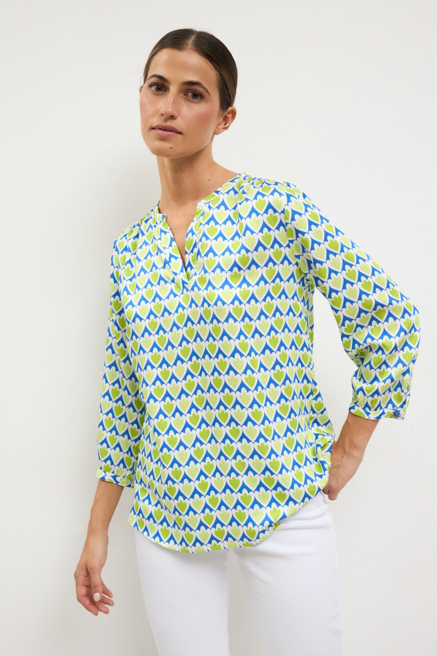 Model wearing Bariloche 3943745 Jara Shirt in green and blue heart pattern by bariloche, shop bariloche at Dotique