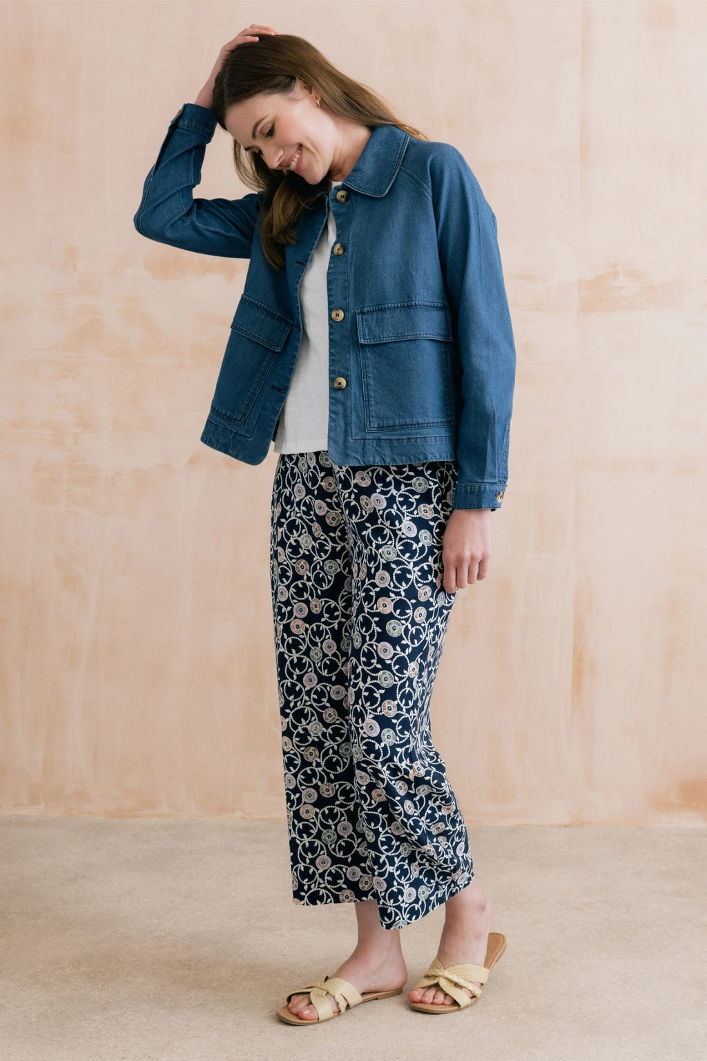 Woman wearing Lily & Me LM26023 Greta Trousers Sea Holly Navy with floral print, paired with a denim jacket by Lily & me. Shop Lily & me at Dotique.