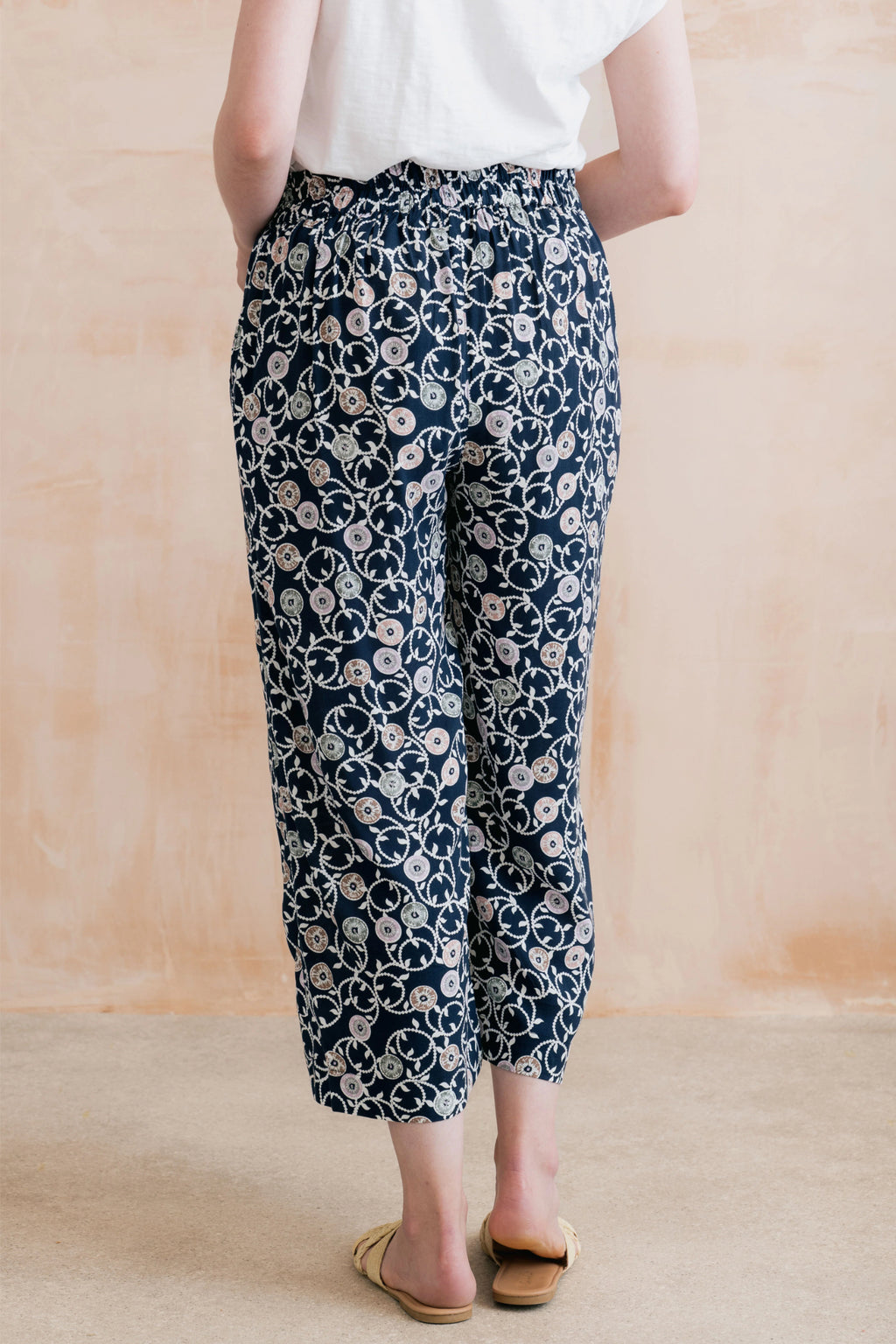 Model wearing Lily & Me LM26023 Greta Trousers Sea Holly Navy with floral print and elastic waist by Lily & me. Shop Lily & me at Dotique.
