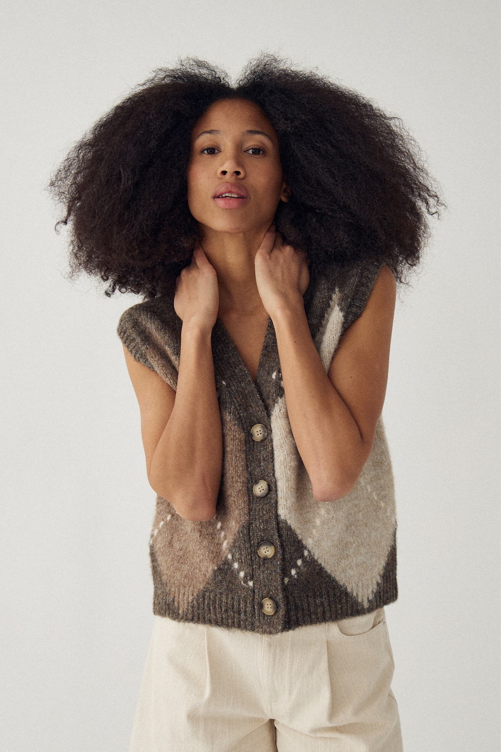 The Noella N-Laiana Knit Vest in Ash Brown Mix. Combining warm mocha, oatmeal, taupe and soft cream tones in a statement argyle design. Shop at Dotique.