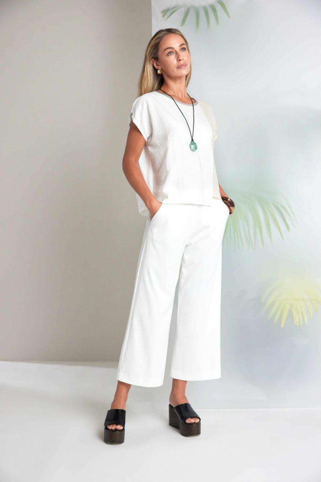 Model wearing Naya NAS26237 Cream Wide Leg Pull-On Trousers by Naya, shop the vendor at Dotique for stylish comfort.