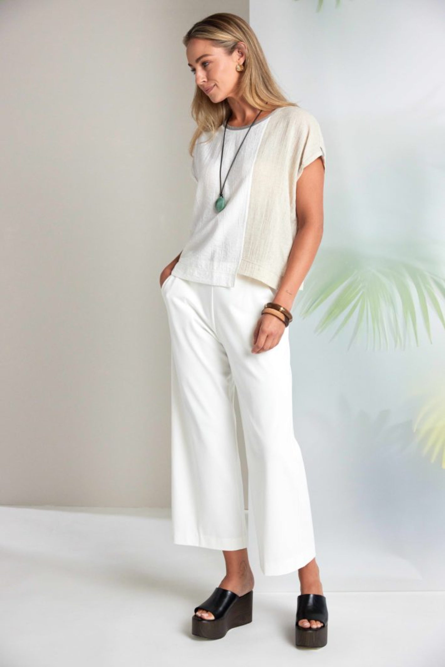 Woman wearing Naya NAS26237 Cream Wide Leg Pull-On Trousers by Naya, available to shop at Dotique.