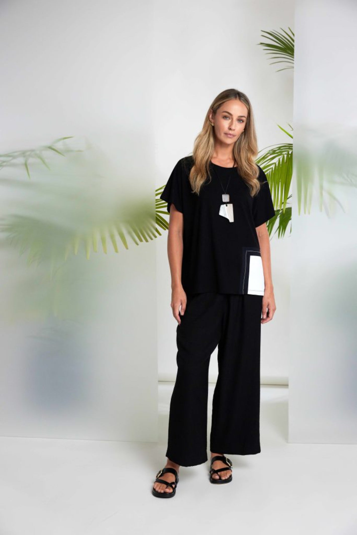 Woman dressed in Naya NAS26188 Round Neck Top with Contrast Pocket in Black & White by Naya shop Dotique